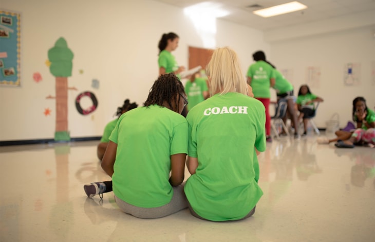 Coach and girl sitting together